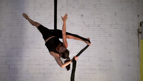 Display-of-strength-and-flexibility-performed-by-a-slim-and-fit-female-acrobat-performing-aerial-acrobatics