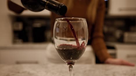 Closeup-Of-A-Wineglass-With-Red-Wine-Pouring