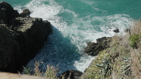 Rocky-Coastline-Hit-By-Ocean-Waves-On-A-Sunny-Summer-Day