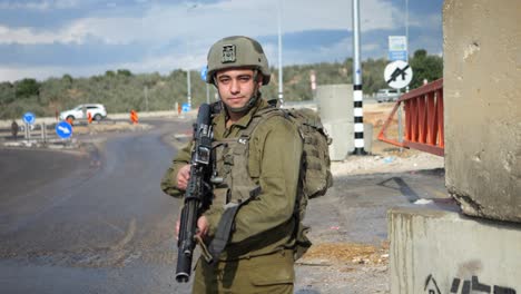 Golani-Unit-IDF-Soldier-in-Uniform-with-Machine-Gun-at-Roadblock-Checkpoint-Daytime---Dolly-From-Medium-to-Portrait