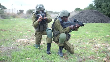 Dos-Soldados-De-Infantería-Del-Ejército-Israelí-De-Las-FDI-En-Posición-Arrodillada-Con-Ametralladoras-En-La-Zona-Rural-Del-Campo-De-Entrenamiento---Disparo-En-órbita