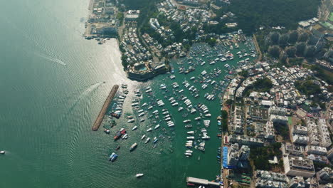 Orbit-Drone-top-shot-of-bustling-harbor-and-tall-building-in-Hongkong,-China