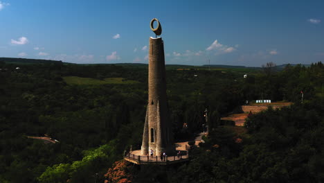 Candle-of-Gratitude-Stone-Monument-On-Top-of-Hill-in-Soroca-Moldova,-Aerial-View-of-Thanksgiving-Candle-Building,-Tourist-Destination