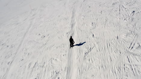 A-drone-follows-a-skier-on-Chopok-mountain-in-Jasna,-Low-Tatras,-Slovakia