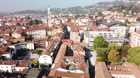 Iconic-Bergamo-city-rooftops-and-downtown,-aerial-fly-backward