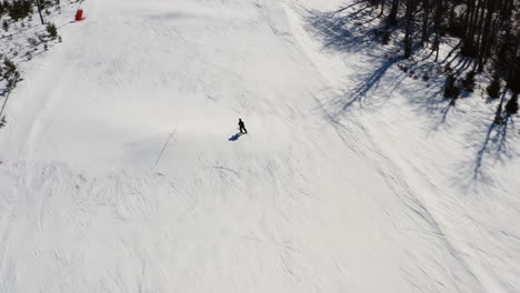 Drone-follows-skier-on-Chopok-mountain-in-Jasna,-Low-Tatras,-Slovakia