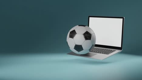 El-Fútbol-Frente-A-La-Computadora-Portátil-Con-Pantalla-Blanca-Cae-En-El-Marco