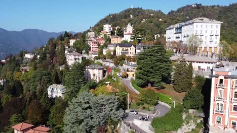 Village-of-Brunate-on-top-of-green-mountain,-aerial-drone-view