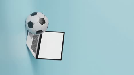 Blank-laptop-screen-mockup-with-football,-vertical-3d-animation-with-text-space