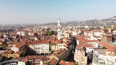 White-church-tower-of-Bergamo-township-on-sunny-day,-aerial-view