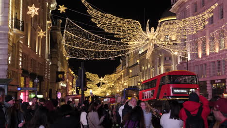 Crowd-Of-People-And-Traffic-On-Bustling-Street-With-Christmas-Lights-Hanging