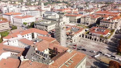 Bell-tower-under-construction-in-downtown-Bergamo,-aerial-orbti-view
