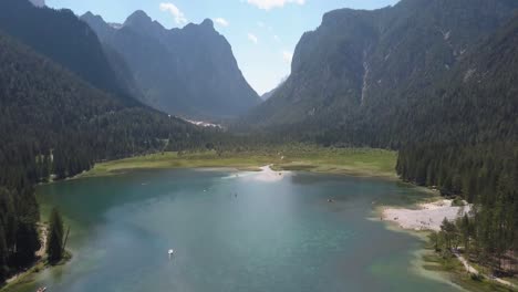 Summer-holiday,-green-lake-in-the-mountains-in-Europe-at-Lago-di-Dobbiaca-next-to-hotel-Baur-Al-Lago