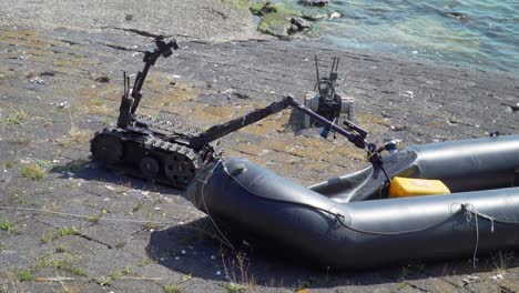 EOD-Robot-Grabs-Yellow-Case-in-Rubber-Boat-Exercise,-Sandy-Coast-2021