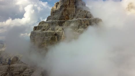 Descending-aerial-view-of-a-Single-Mountain-Peak-Cliff-Ridge-Three-peaks-of-Tre-Cime-Lavaredo,-Alps,-Belluno,-Dolomite,-Italy