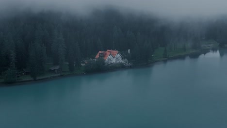 Aerial-drone-footage,-house-at-the-lake,-moody-day