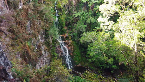 Idyllic-waterfall-hidden-away-in-lush-green-canyon-giving-a-romantic-feeling