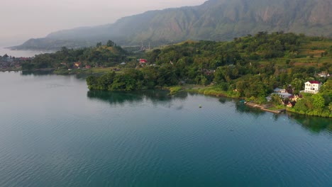 Aerial-view-of-blue-Lake-Toba-and-Samosir-Island-in-North-Sumatra,-Indonesia---tilting-+-pedestal-up