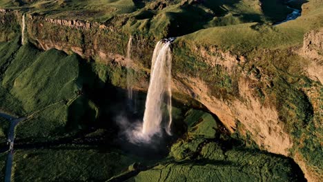 Aerial-drone-footage-of-Seljalandsfoss-waterfall-in-Iceland-during-sunset
