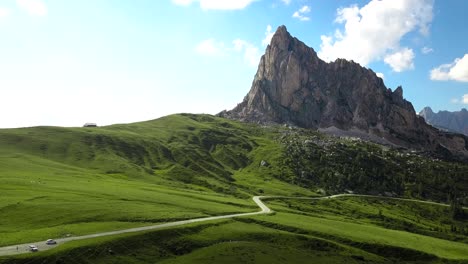 Small-country-road-up-in-the-mountains-towards-a-high-cliff,-Passo-di-Giau,-Alps,-Dolomiti,-Belluno,-Italy