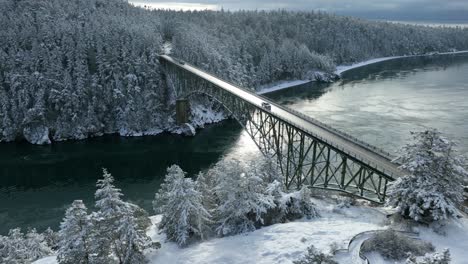 Wide-aerial-view-of-Deception-Pass-Bridge-on-Whidbey-Island-with-snow-covering-the-ground