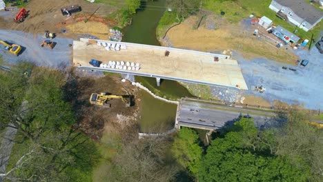 Aerial-View-of-Farmlands-and-a-Bridge-being-Replaced-over-a-Stream-on-a-Beautiful-Sunny-Day