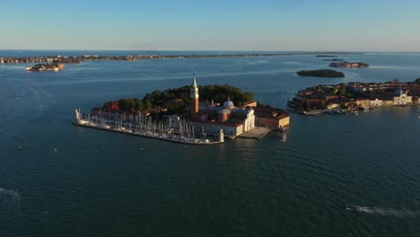 Aerial-view-flying-to-Church-of-San-Giorgio-Maggiore-during-sunset-in-Venice-in-Italy-in-4k