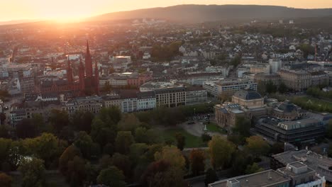 Drone-Circle-Shot-around-City-center-of-Wiesbaden-in-Germany-at-best-light-showing-the-Marktkirche-and-the-Kur-Area-with-its-parc