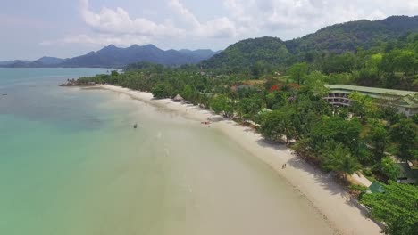 Ascending-Aerial-shot-tourist-beach-in-tropical-Koh-Chang-with-Jungle-sea-view