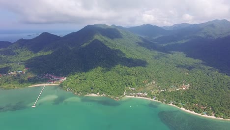 High-Aerial-side-pan-shot-of-Koh-Chang-with-sea,-Jungle-and-mountains-and-clouds