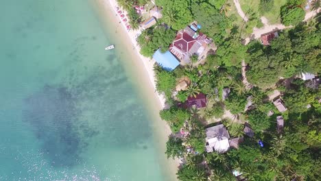 Aerial-down-vertical-shot-of-a-tourist-beach-on-Koh-Chang-with-Jungle-and-sea-and-bungalow-resorts