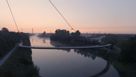 Germany---Bike-Ride-on-Bridge-Path-over-Rhine-Herne-Canal,-Aerial-Establishing-Drone-View
