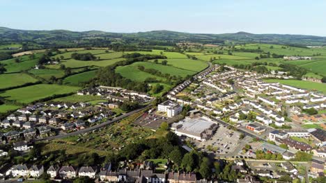 Denbighshire-residential-suburban-North-Wales-countryside-town-housing-estate-aerial-view-pan-right