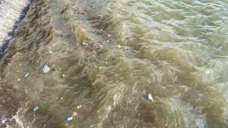 Garbage-and-Litter-in-Polluted-Murky-Water-on-Beach-Coast---Importance-of-Recycling,-Environmental-Marine-Life-Protection