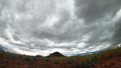 Low,-wide-angle-view-of-storm-clouds-blowing-over-the-desert-landscape-in-this-dramatic-time-lapse