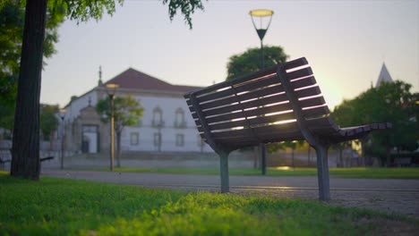 wooden-park-bench-at-sunset-on-city-park