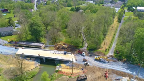 Aerial-View-of-Farmlands-and-a-Bridge-being-Replaced-over-a-Stream-on-a-Beautiful-Sunny-Day