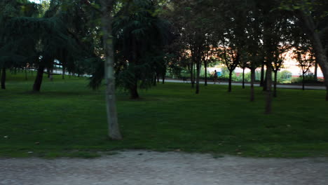 Pan-left-shot-of-a-woman-in-a-mask-running-in-the-Enrique-Tierno-Galván-Park
