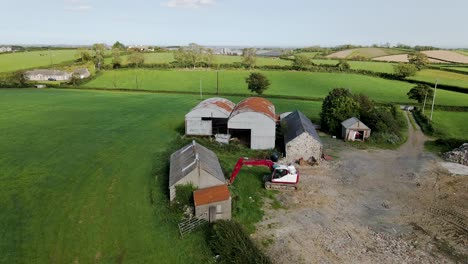 Tilt-down-aerial-view-of-barns-and-farmhouse-in-Irish-countryside