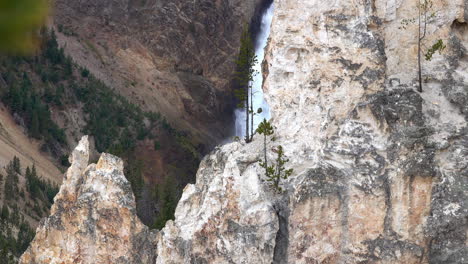 Rock-formations-and-a-glimpse-of-the-Lower-Falls-in-the-Grand-Canyon-of-Yellowstone