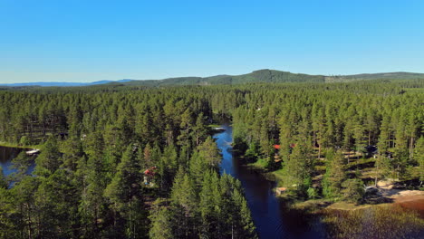 Scenic-Beauty-Of-Coniferous-Forest-And-Camping-Site-By-The-River-In-Summer-At-Vansbro-Municipality,-Dalarna-County,-Sweden
