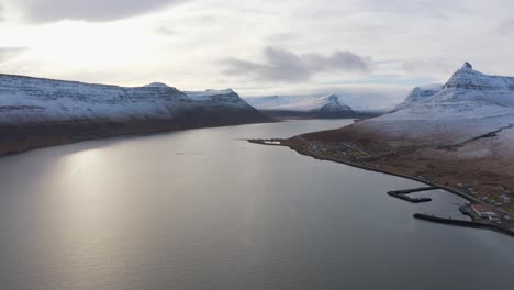 Panning-across-Magnificent-Snow-Covered-Mountains-Surrounding-Large-River-The-Westfjords,-Drone-Aerial
