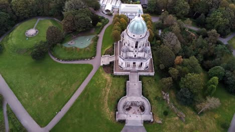 Historic-Ashton-memorial-English-folly-classical-landmark-Lancashire-countryside-gardens-aerial-birdseye-orbit-left-view