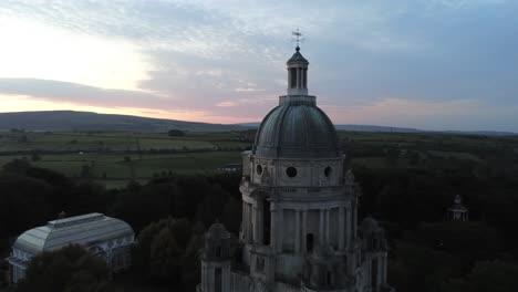 Wealthy-Ashton-memorial-English-ornate-dome-folly-landmark-Lancashire-countryside-sunrise-Aerial-pull-away-view