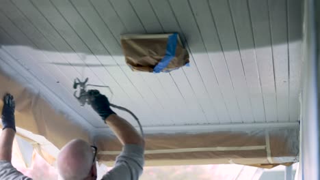House-Painter-Applying-White-Paint-To-House-Ceiling-With-An-Airless-Paint-Sprayer