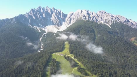 Ski-slope-during-the-summer-in-Innichen-South-Tirol,-green-no-snow,-mountain-top-peaks