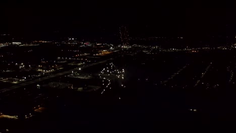 Aerial-shot-of-fireworks-with-city-lights-in-the-background