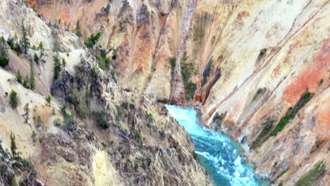Tilting-and-panning-shot-of-colorful-canyon-walls-and-rocks-in-the-Grand-Canyon-of-Yellowstone