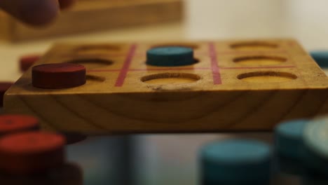 Players-playing-tick-tack-toe-rustic-wooden-hand-made-strategy-game-closeup