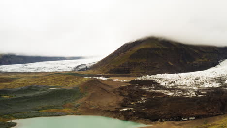 Aerial-shot-of-a-landscape-of-lake-and-mountain-in-the-Fjallsárlón-area